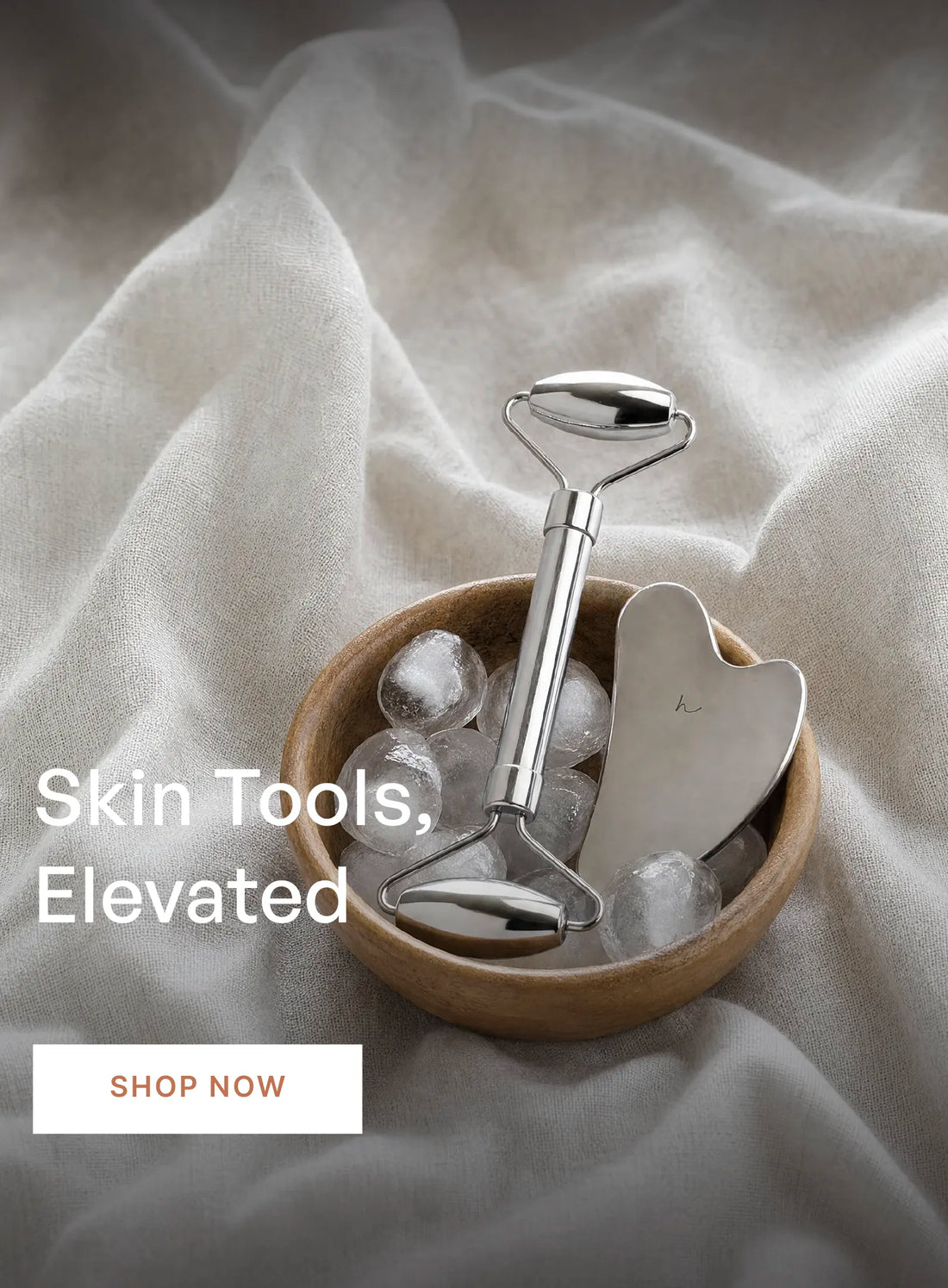 Skin Tools, Elevated. Hawa stainless steel gua sha and facial roller in a wooden bowl of ice. Shop now.