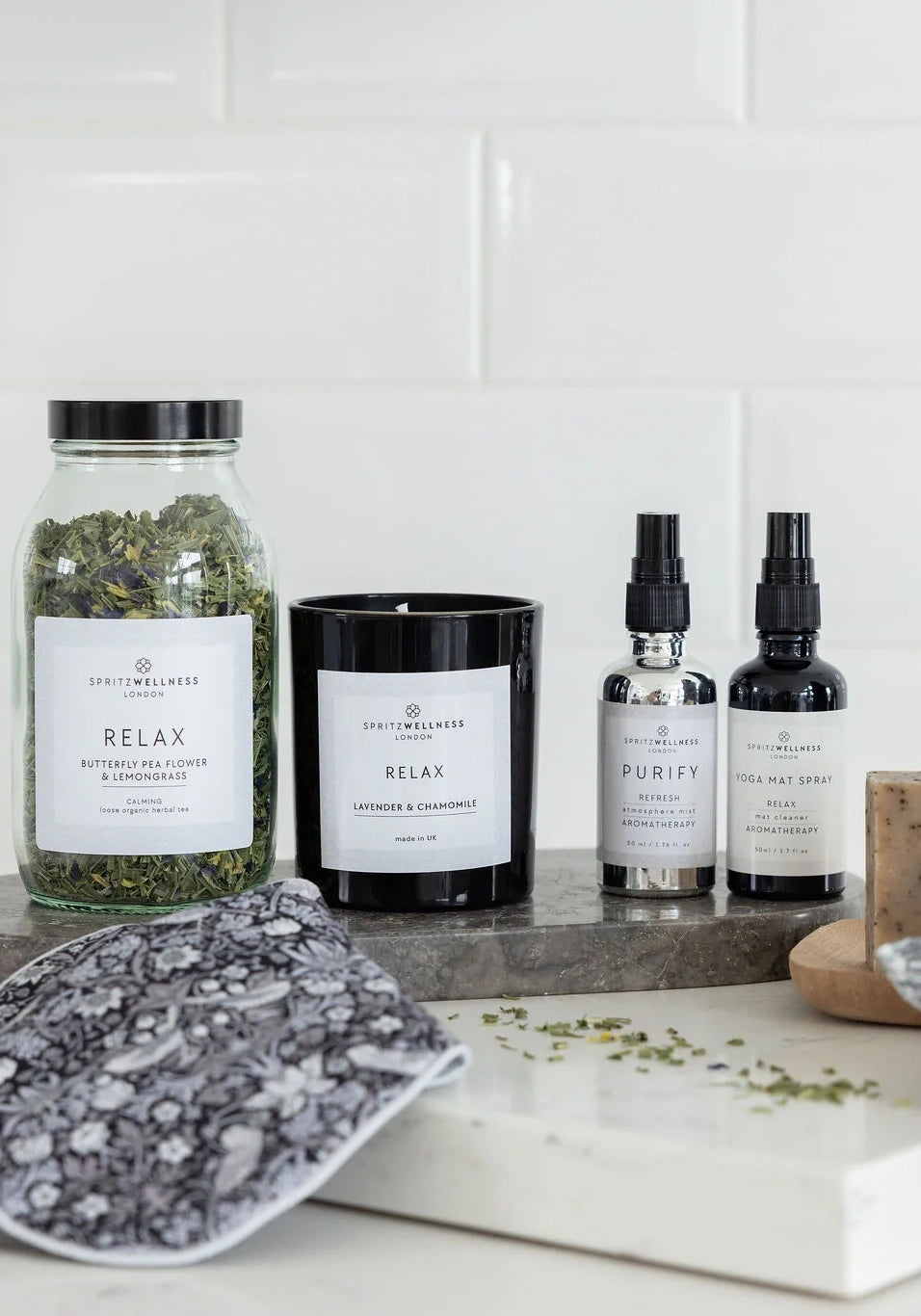 Spritz Wellness relaxing herbal tea, candle and aromatherapy mists on a marble board