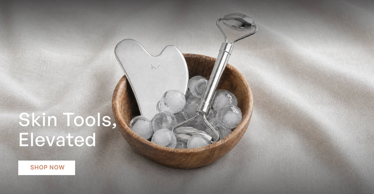 Skin Tools, Elevated. Hawa stainless steel gua sha and facial roller in a wooden bowl of ice. Shop now.