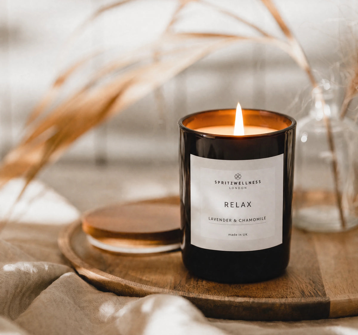 Seasonal Self-Care: Spritz Wellness Relax candle on a wooden tray