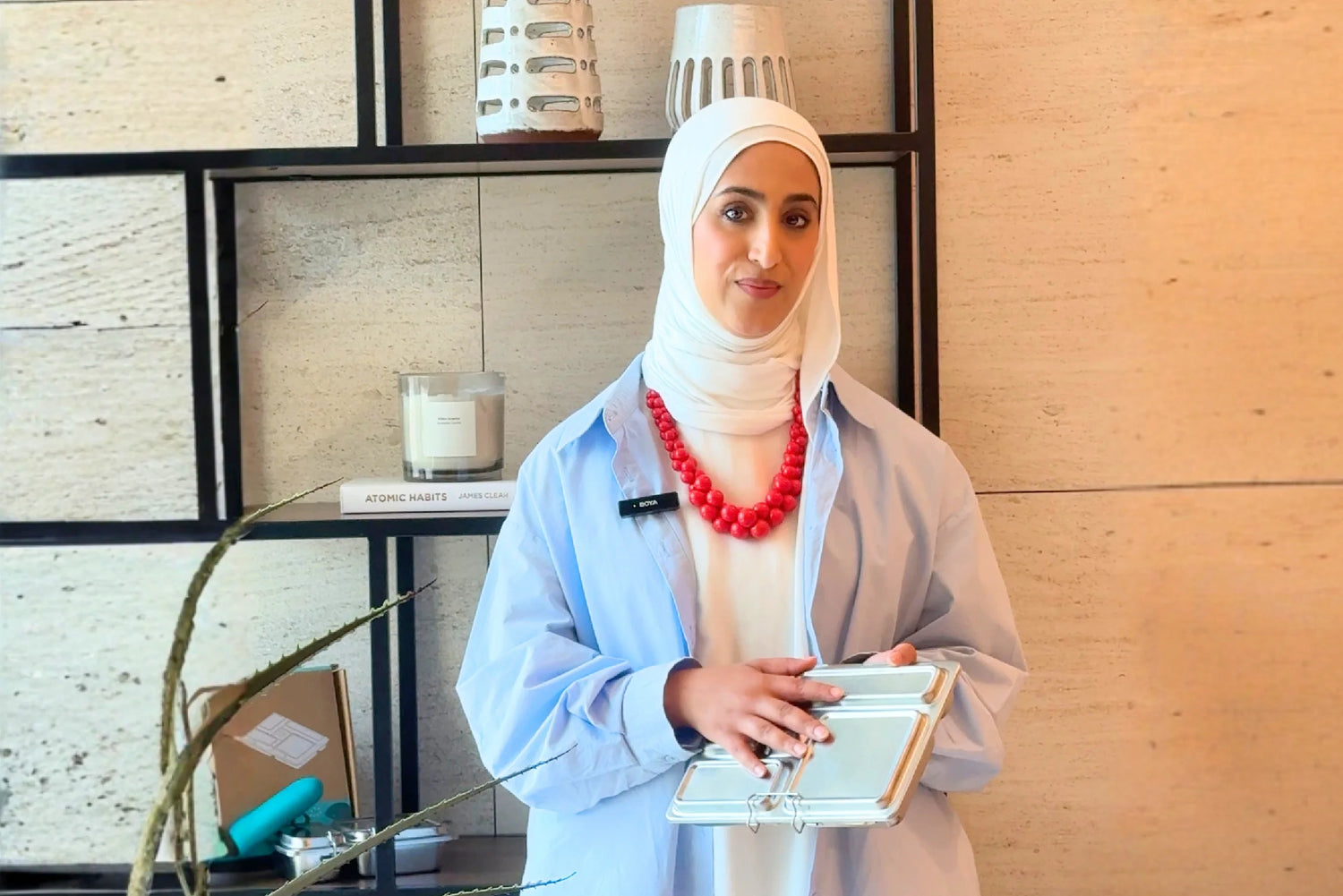 Basmah AlWuhaib holding a stainless steel lunch box — Build a Balanced Lunch Box Workshop at Waha Lifestyle Kuwait