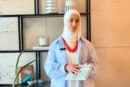 Basmah AlWuhaib holding a stainless steel lunch box — Build a Balanced Lunch Box Workshop at Waha Lifestyle Kuwait