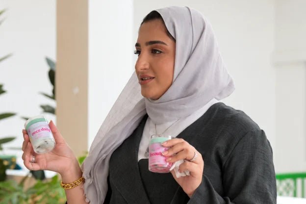 Jumana AlAwadhi holding two handmade candles — Create Your Own Non-Toxic Candle Workshop at Waha Lifestyle Kuwait