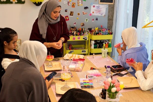 Participants making and decorating their own candles at a candle-making workshop
