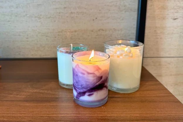 Three finished handmade candles in glass jars